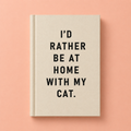Cream A7 fabric hardback notebook with black I’d Rather Be At Home With My Cat text on a peach background.