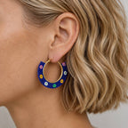 Navy floral beaded hoop earring worn on the ear, showing the statement hoop design and colourful beadwork.