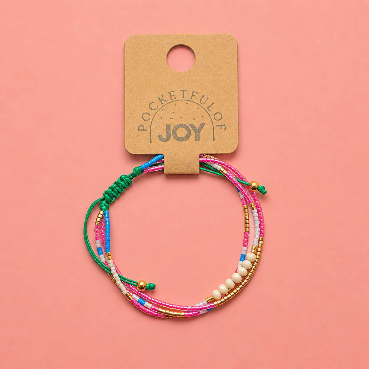 Pink, turquoise and gold adjustable beaded bracelet displayed on a Pocketful of JOY jewellery card.