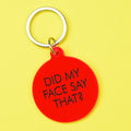 Bright red round statement keyring with black Did My Face Say That lettering and silver-tone metal keyring attachment.