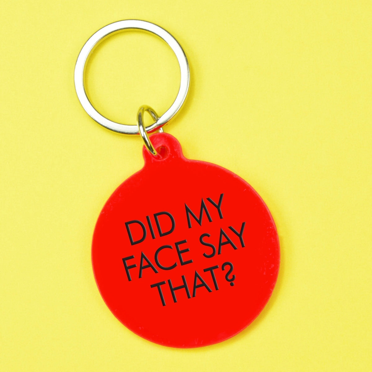 Bright red round statement keyring with black Did My Face Say That lettering and silver-tone metal keyring attachment.