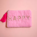 Pink velvet zip pouch with sparkling beaded and sequin ‘HAPPY’ lettering and bright pink tassel zip pull.
