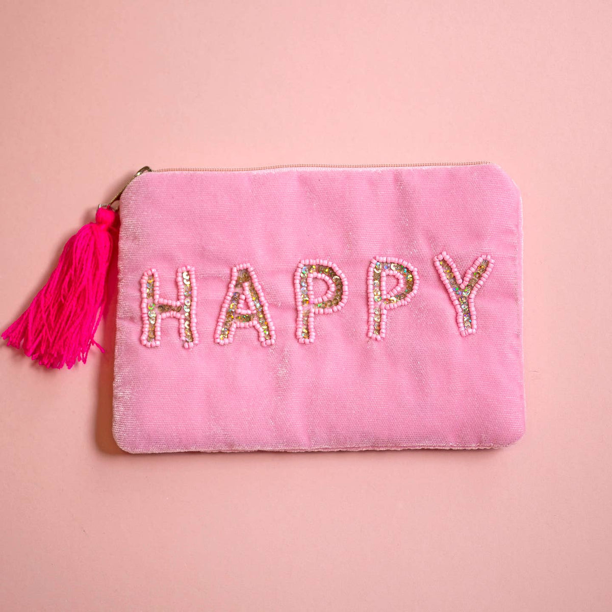 Pink velvet zip pouch with sparkling beaded and sequin ‘HAPPY’ lettering and bright pink tassel zip pull.