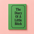 Green A7 hardback notebook with black text reading The Diary Of A Little Bitch on a pale pink background.