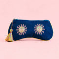 Navy velvet glasses pouch with two colourful beaded sun motifs, gold edging and a multicoloured tassel.