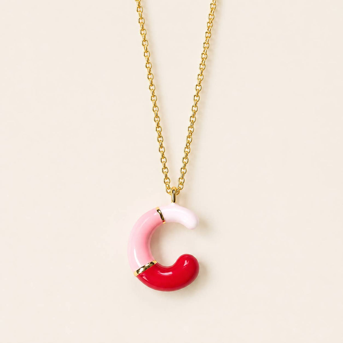 Pink, red and blush enamel C initial pendant necklace with polished gold-tone detailing.