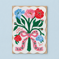 Colourful birthday card featuring red, pink and blue flowers tied with a large pink floral bow and Happy Birthday to you message.