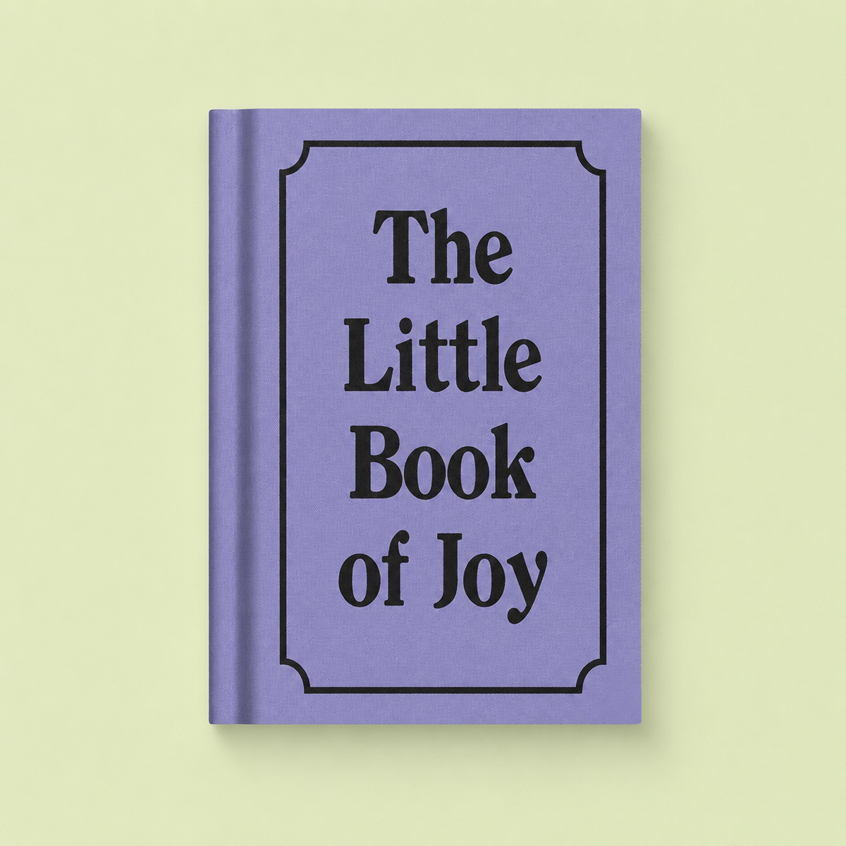 Lilac A7 fabric hardback notebook with black The Little Book of Joy lettering on a pale yellow background.