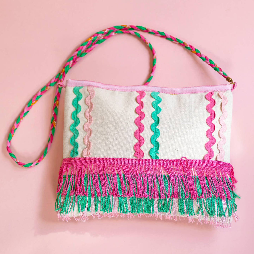 Joyful pink and green fringed canvas bag with wavy ric rac trim, layered tassel fringe and a colourful braided strap.