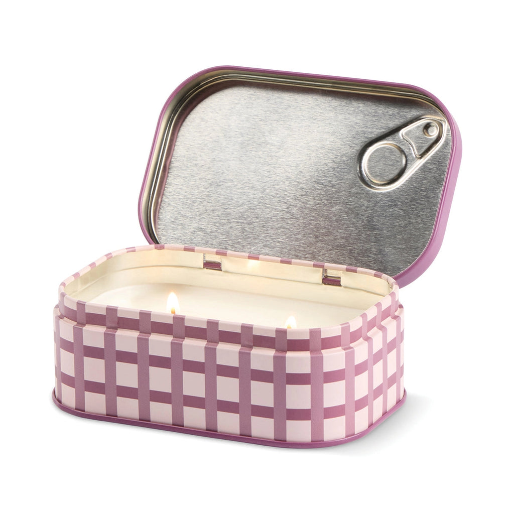 Open Christmas Pudding candle tin with two lit wicks and a pink checked design around the outside.
