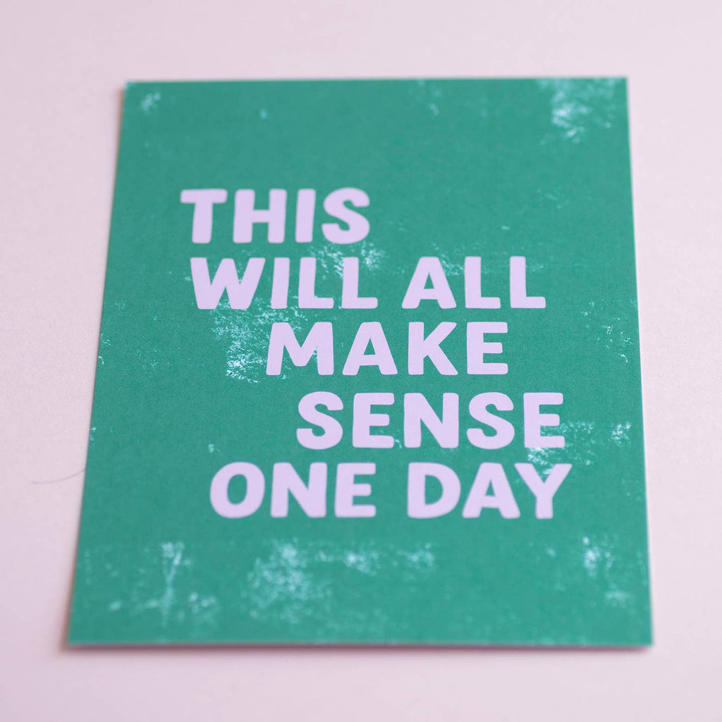Reassuring A5 quote print with lilac typography on a textured green background, photographed against soft pink.