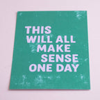 Reassuring A5 quote print with lilac typography on a textured green background, photographed against soft pink.