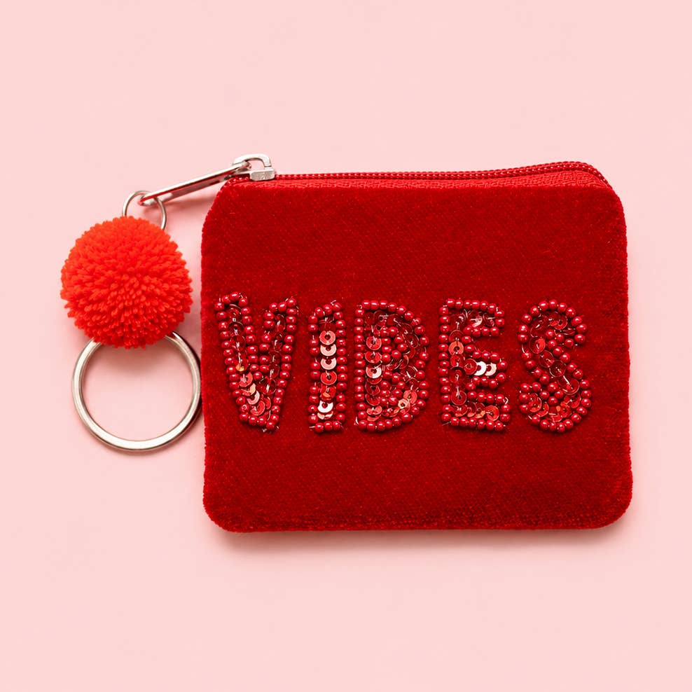 Red velvet mini keyring purse with tonal red beaded and sequin ‘VIBES’ lettering, red pom pom and silver tone keyring.