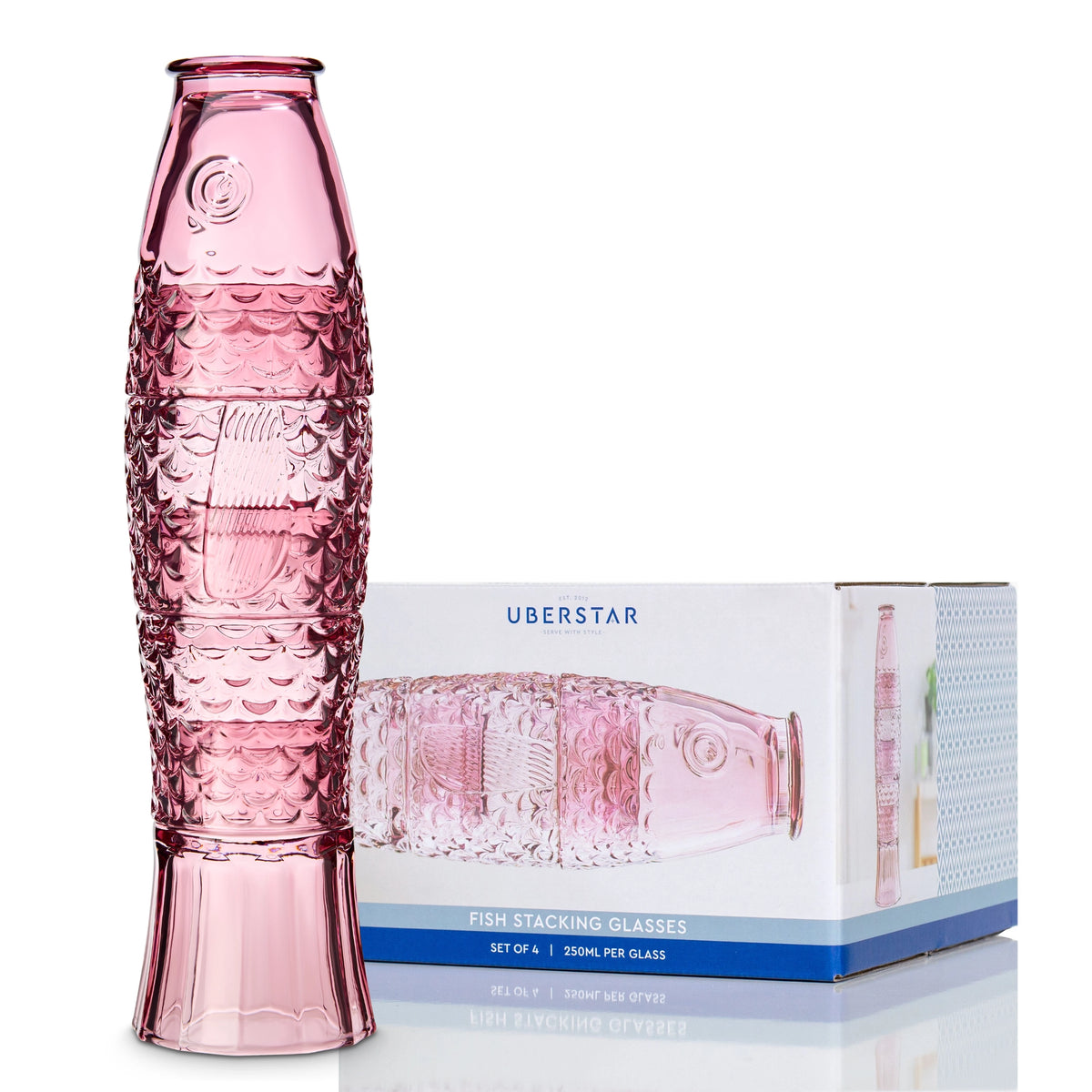 Pink fish stacking glass set assembled beside its presentation box.