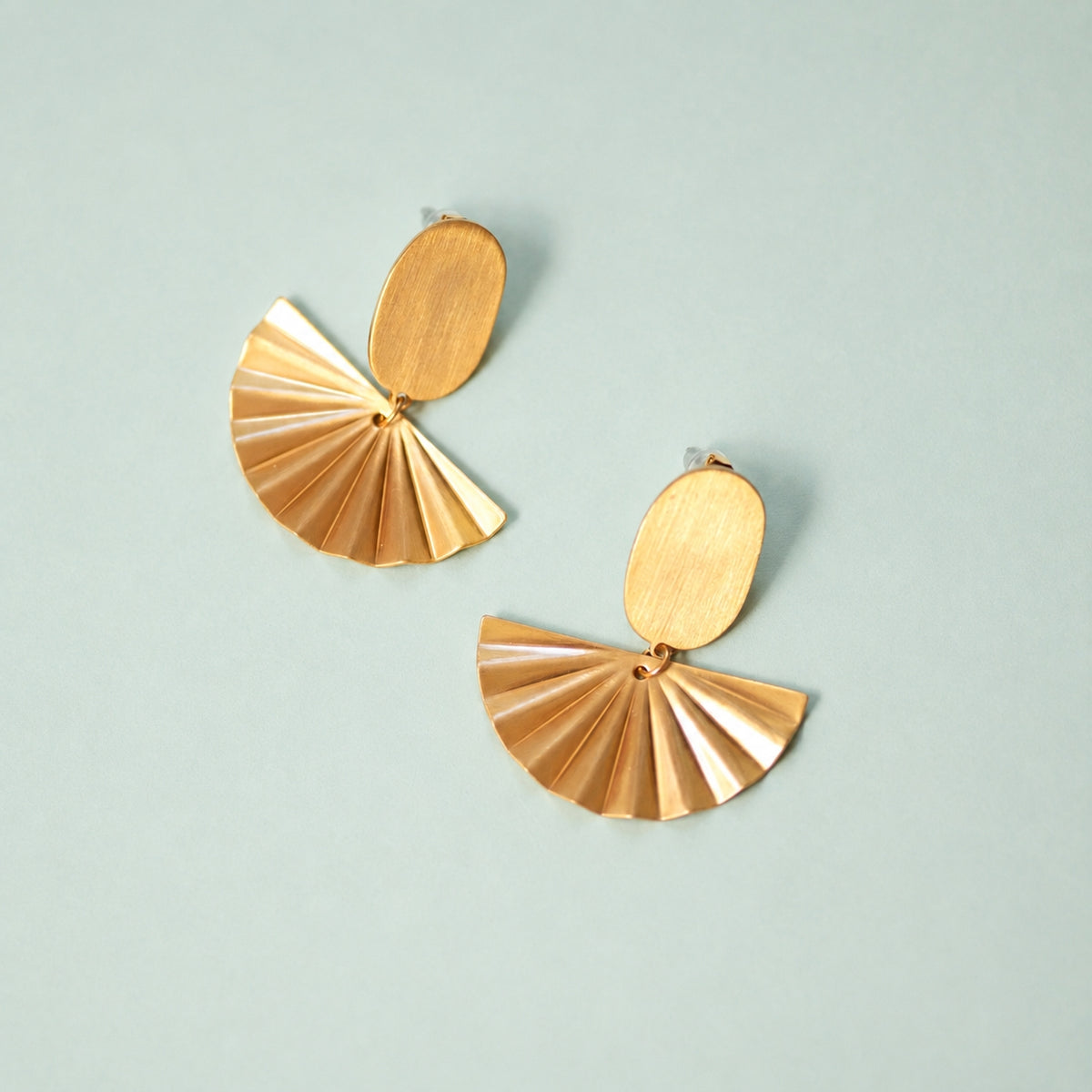 Gold plated statement earrings with sculptural fan-shaped drops, a thoughtful jewellery gift for her.