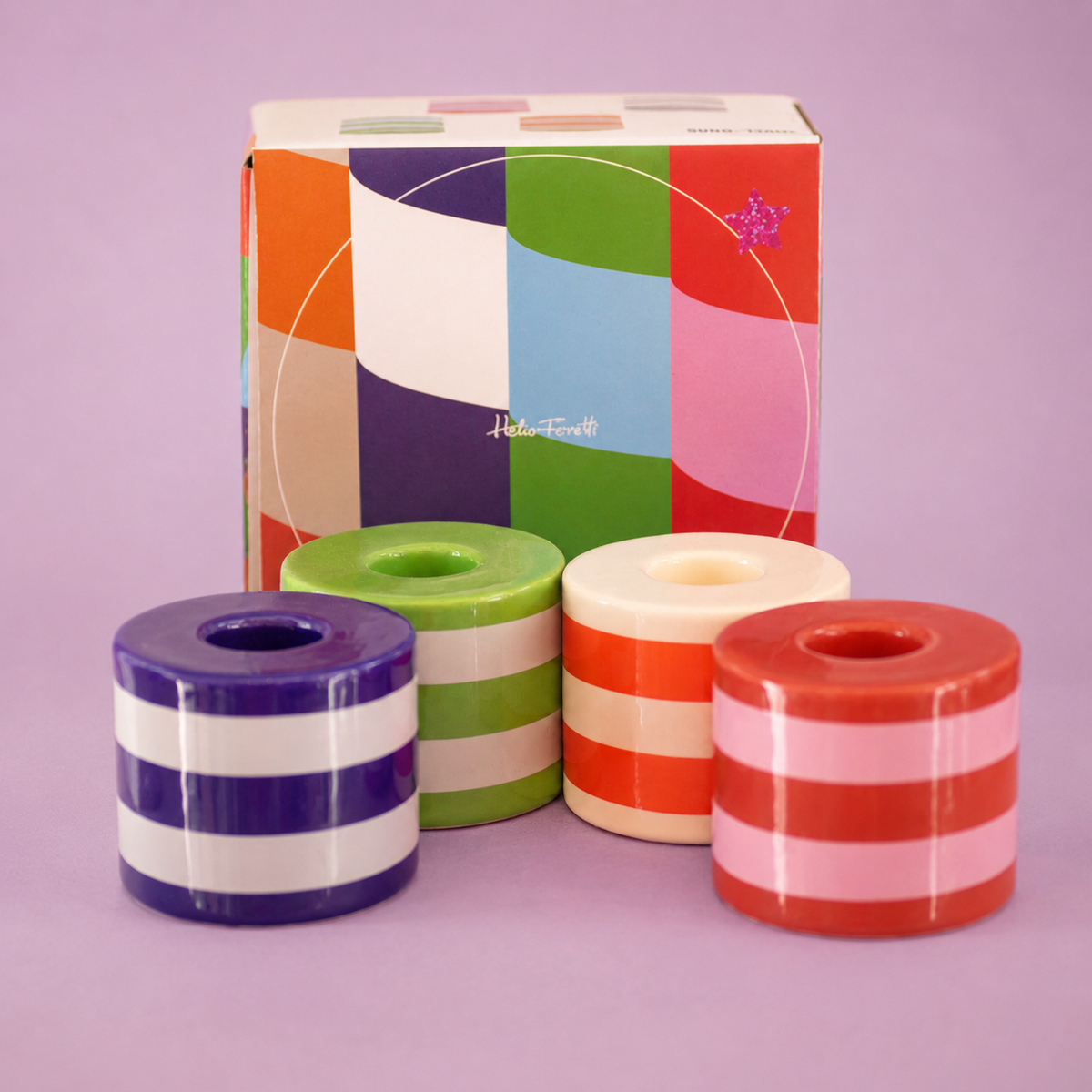 Set of four chunky striped ceramic candlestick holders in purple, green, orange, red, pink and cream with colourful presentation box.