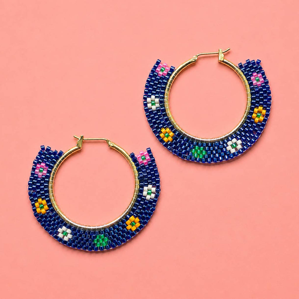 Pair of navy beaded hoop earrings with colourful pink, green, yellow and white floral details.