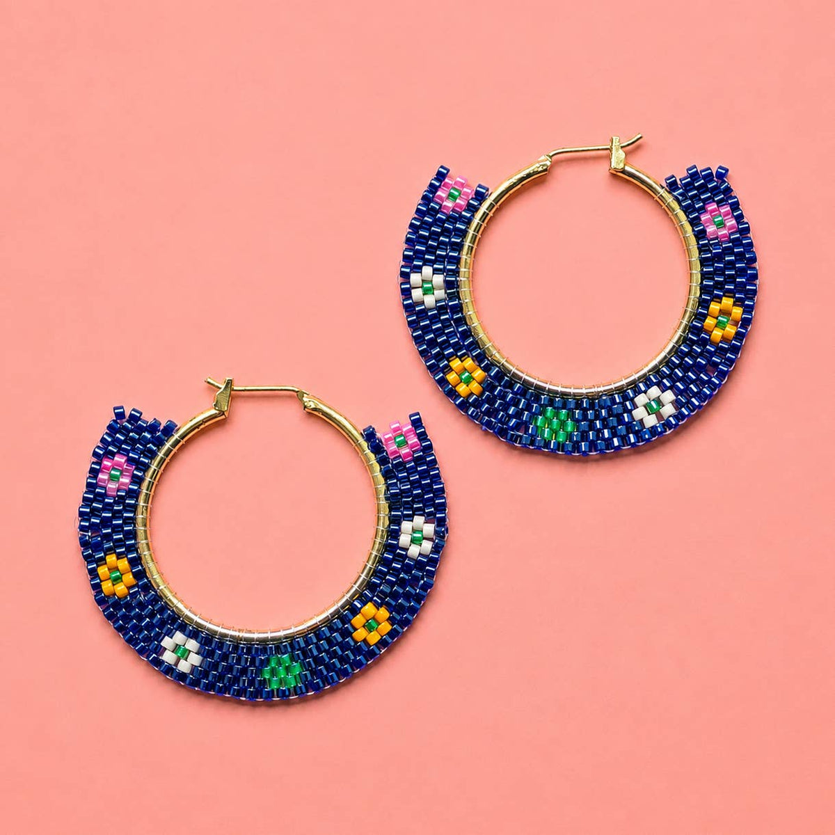 Pair of navy beaded hoop earrings with colourful pink, green, yellow and white floral details.