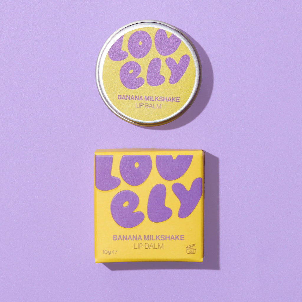 Banana Milkshake Lip Balm 10g tin and yellow box displayed against a lilac background.