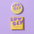 Banana Milkshake Lip Balm 10g tin and yellow box displayed against a lilac background.