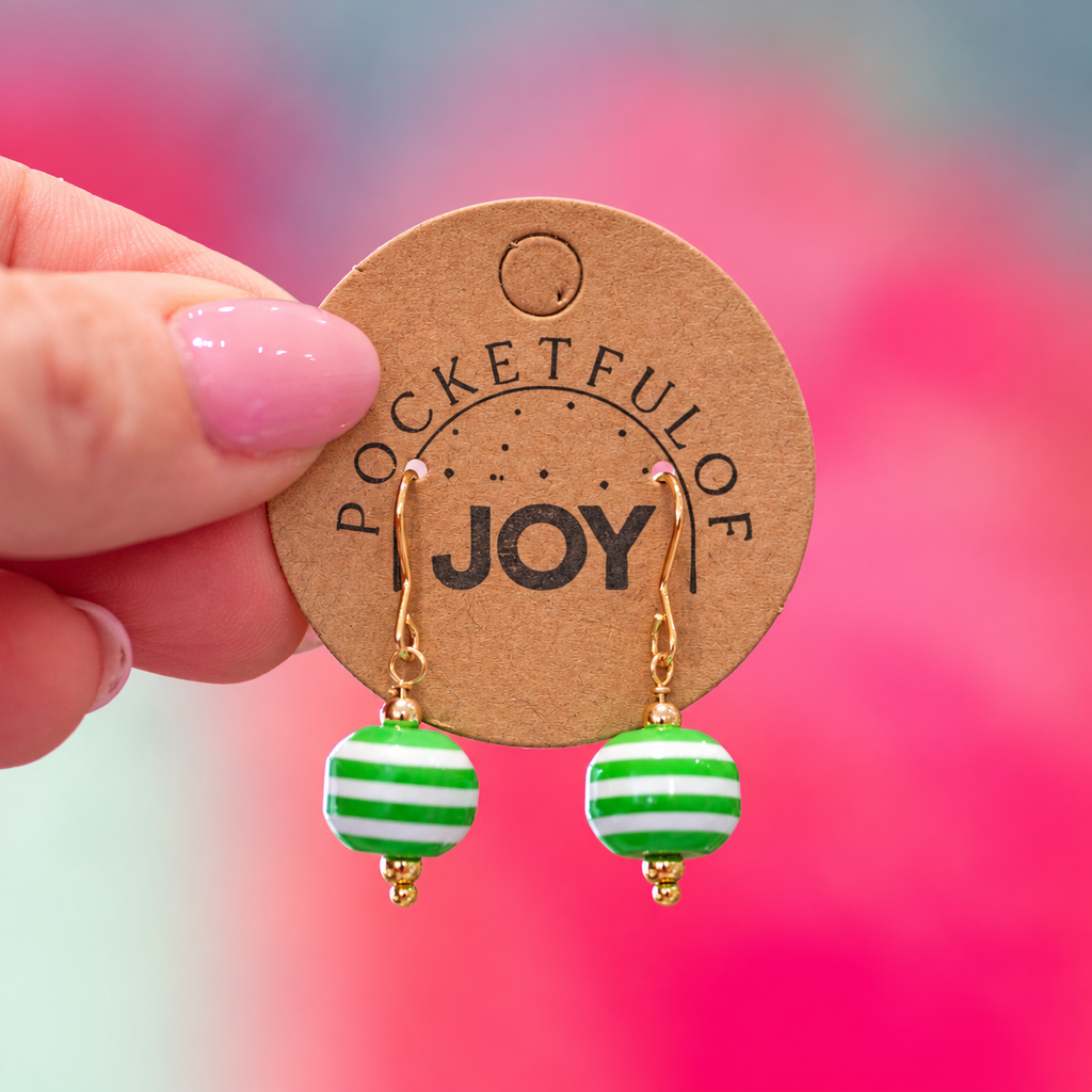 Limited edition green and white striped retro acrylic drop earrings on a Pocketful of Joy card.