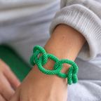 Chunky green beaded statement chain bracelet worn on the wrist showing its oversized textured