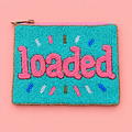 A square turquoise beaded pouch with pink embroidered lettering reading 'loaded' and small multicolor decorative accents, shown on a solid pink background.