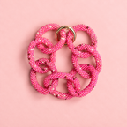 Pink mix chunky beaded chain bracelet with oversized interlocking links and gold tone detail on a soft pink background.